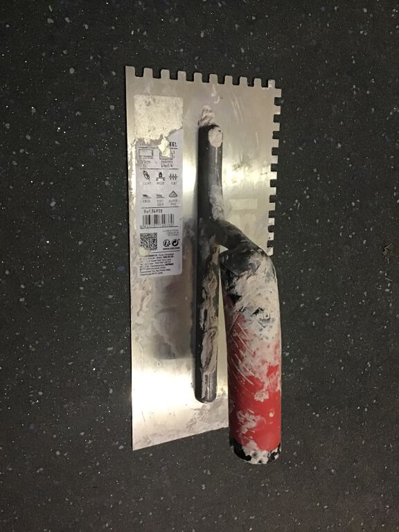 Notched Trowel with red grip handle