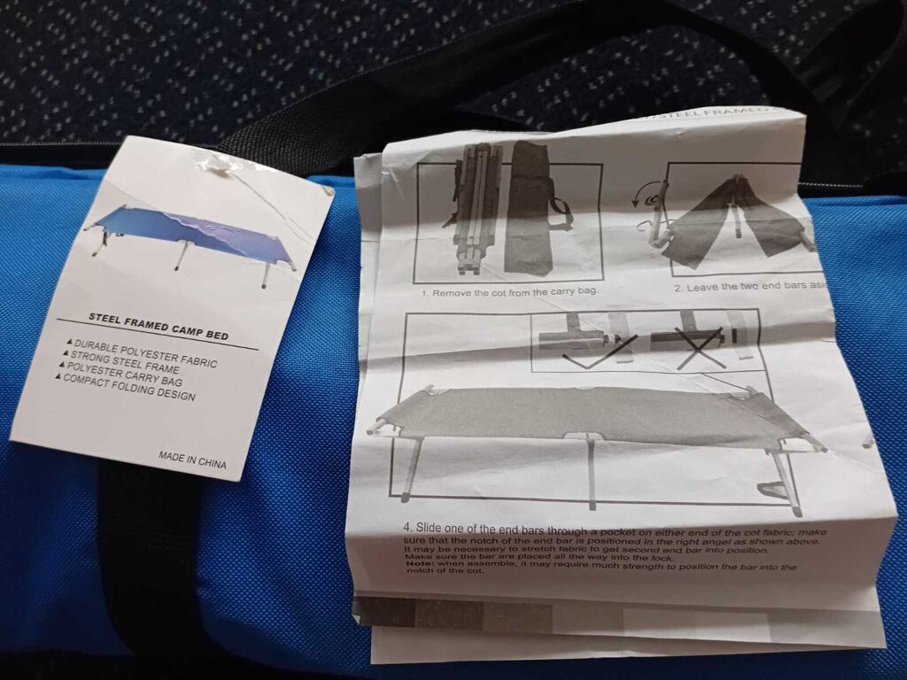 Steel framed camp bed, in blue carry holdall