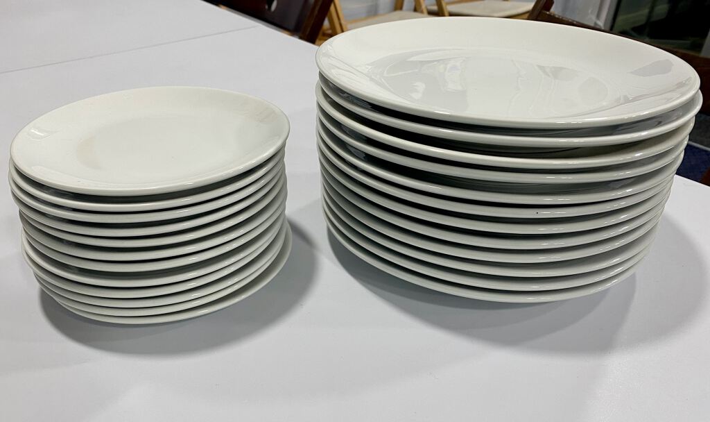 23 White plates comprising of 12 dinner and 11 side plates