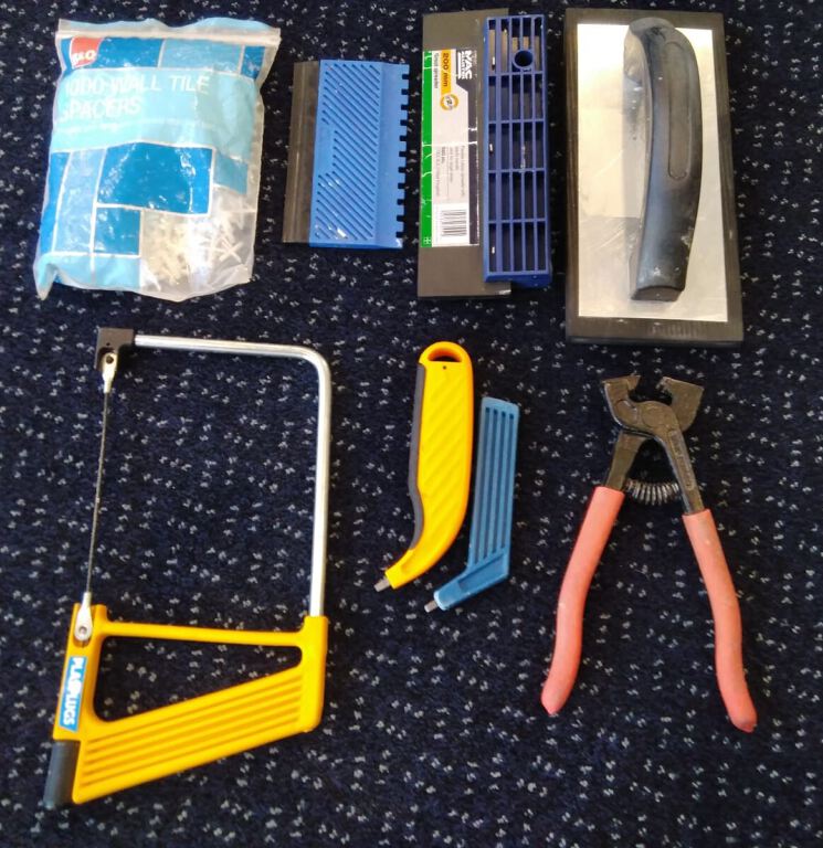 Tiling Tool Assortment: Saw, tile nippers, grout applicators, adhesive aplicator, tile spacers
